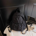Minimalist black nylon backpack with crinkled texture and dual zippers for daily commute - Black