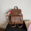 Vintage brown leather backpack with silver turn-lock closure and white plush dog charm - Brown (With Charm)