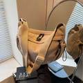 Khaki corduroy crossbody dumpling bag with wide shoulder strap and side drawstring detail - Khaki