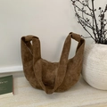 Brown suede hobo crossbody bag with stylish knotted strap detail in a lifestyle setting - Brown