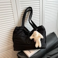Black quilted down tote bag with cute white plush bunny charm for a stylish winter look - Black With Pendant