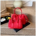 Detail of red suede patchwork bucket bag set on stairs with elegant lifestyle accessories - Large Size Red