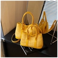 Detail of yellow matte leather bucket bag set with metal snap and shoulder strap - Large Yellow