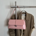 Pink glossy faux leather baguette bag with silver G buckle on a metal hanger - Pink
