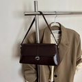 Dark brown glossy leather baguette bag with silver G buckle and adjustable strap - Brown