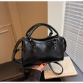 Fashionable black glossy faux leather handbag with silver rivets and dual top handles - Black