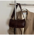 Detail of broad shoulder strap with silver rivets on a brown faux leather baguette bag - Brown