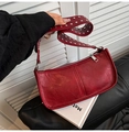 Fashionable red underarm bag with silver studs on wide shoulder strap and oily leather texture - Red
