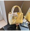 Chic yellow mini bucket bag in lychee leather with white ribbon and pearl strand decor - Yellow