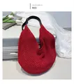 Macro view of red crochet tote bag featuring hollow mesh weave and leather straps - Red
