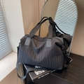 Large black crossbody travel bag with unique pleated texture and adjustable wide strap - Black