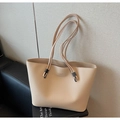 Close-up of beige lychee texture faux leather tote bag with brand logo lettering - Khaki