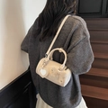 Chic beige cylindrical crossbody bag with bow detail and heart mirror pendant shown on model - Off-white