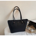 Detail of black faux leather tote bag with white stitching and branded logo on the front - Black