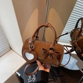 Brown barrel handbag in shiny finish with heart mirror and bow decoration accessory - Coffee