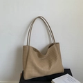Detail view of khaki woven PU leather texture and shoulder strap on a spacious tote bag - Khaki