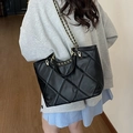 Classic black quilted tote bag with gold chain strap shown in a crossbody style - Black