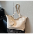Detail of a minimalist off-white tote bag with textured faux leather and small coin purse - White