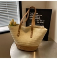 Detail of hand-woven straw tote bag with brown leather handles and white stitching - Off White