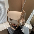 Bolso de hombro tipo silla de montar beige con botones y un colgante de monstruo peludo - Con Colgante / Blanco Roto