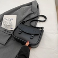 Minimalist black leather saddle crossbody bag with round buckle details and matte finish - No Pendant / Black