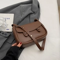 Vintage brown leather saddle bag with flap buckle and adjustable strap in minimalist setting - No Pendant / Coffee