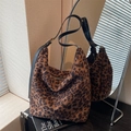 Hobo shoulder bag featuring classic leopard print fabric and adjustable black leather strap - Dark Brown