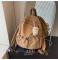 Detail view of brown nylon backpack with drawstring pocket and cute plush charm - With Pendant / Khaki