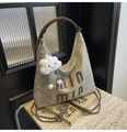 Detail of hobo tote bag featuring vintage green fabric and plush cloud keychain - With Charm / Off White