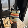 Colorful striped straw bucket bag with black leather trim and crossbody strap - Black