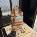 Bohemian striped woven straw crossbody bag with brown leather handles in a vibrant summer style - Brown