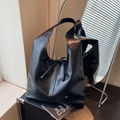 Large black hobo tote bag in textured leather with decorative bow and shoulder strap - Black