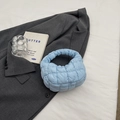 Sky blue quilted puff tote bag with square stitching on a grey blazer background - Light Blue