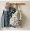 Detailed view of cream nylon backpack featuring drawstring pockets and casual styling - No Pendant / White