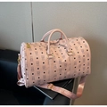 Detailed macro view of pink travel bag with bear patterns and golden hardware accents - Pink