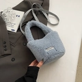 Chic light blue faux fur bucket bag with Clear Heart label on grey suit backdrop - No Pendant / Blue