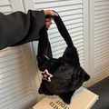 Detailed close-up of soft black plush star-shaped handbag with premium silver zipper - Black