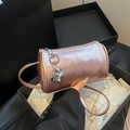 Metallic pink cylinder bag with heart charms on elegant gift box background - Pink