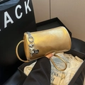 Gold metallic cylinder handbag with heart charm and shoulder strap for spring commute - Gold