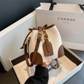Chic two-tone bucket bag in cream pebbled leather with brown trim and gold buckle - Off White