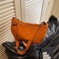 Chic bright orange crescent crossbody bag with adjustable strap and fashion tag - Brown
