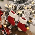 Red and white knitted mini Christmas stockings hanging on a snow-covered Christmas tree - Red Knitted Mini Stocking