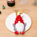 Christmas gnome cutlery holder featuring a red hat and grey heart suit on a dinner plate - Style A