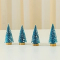 Set of four 10cm blue mini cedar Christmas trees with snow flocking and wood base - Blue