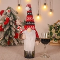 Christmas gnome wine bottle cover with knit hat and candy cane decoration for holiday tables - Holding Cane Style