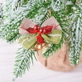 Red and green Christmas bow with golden bells and Merry Christmas text on pine branch - Red Green With Red Leaves Bell Bow