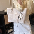 Minimalist beige tote bag with geometric print and horse charm in a cozy home setting - Beige With Charm