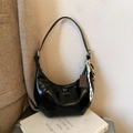 Classic black glossy croissant underarm bag with silver text and chocolate charm - Black