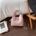 Pink lychee grain leather bucket bag with metal twist lock and thin shoulder strap - Pink