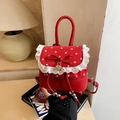 Mini red polka dot backpack with white lace trim and red bow detail in lifestyle setting - Red
